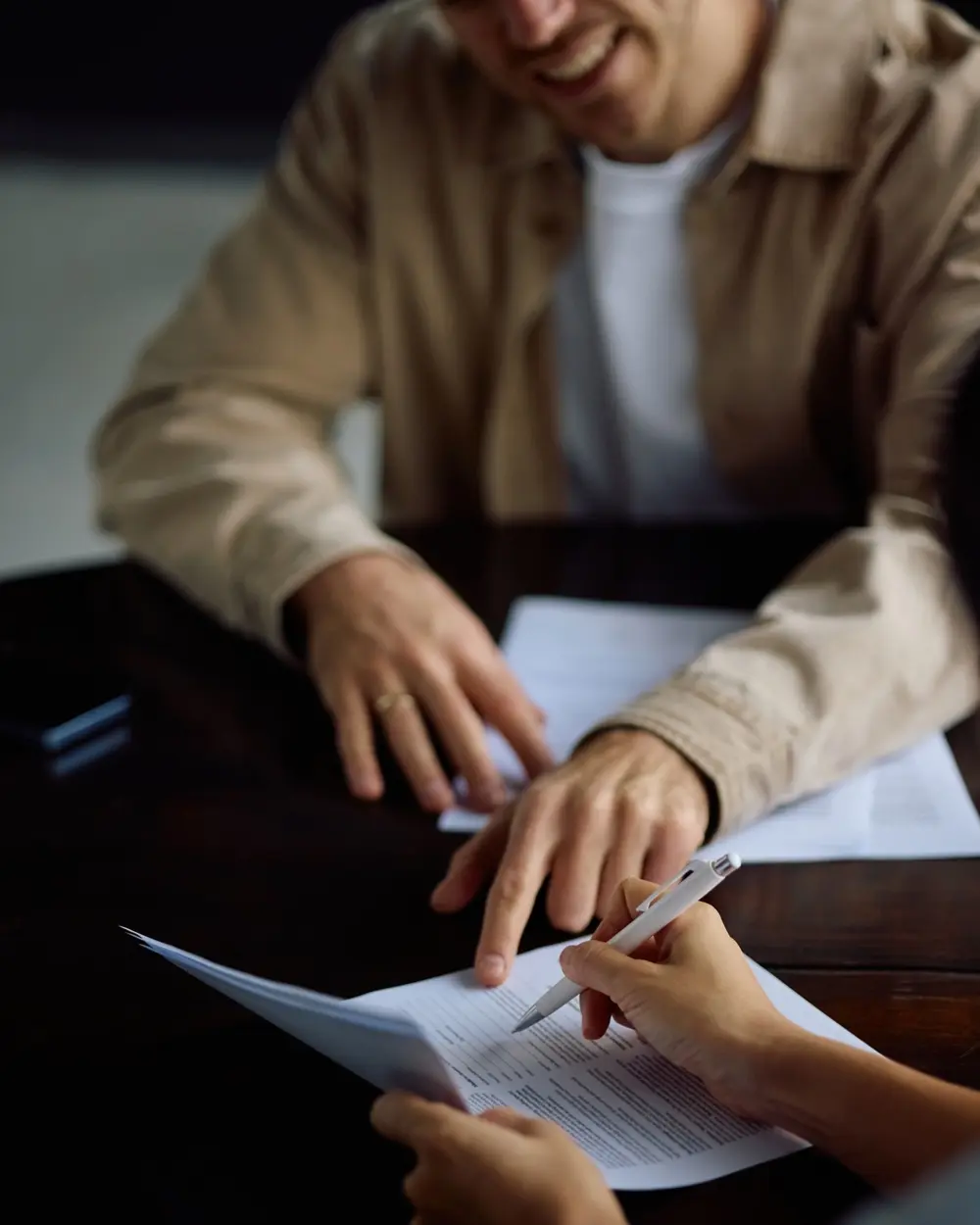 Two people reviewing a document together at a table